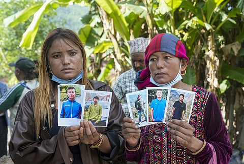 Family members and relatives show photographs of five missing victims amid search operations after the recent flash floods, at Belkotgadhi, Nuwakot district, Nepal, KUSHINAGAR on Sunday, August 30. (PTI Photo)