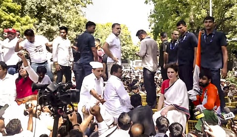 File photo: Rahul Gandhi and Priyanka Gandhi Vadra atop police barricades after their march toward the Election Commission office was stopped in New Delhi on October 6, 2026. (PTI Photo)