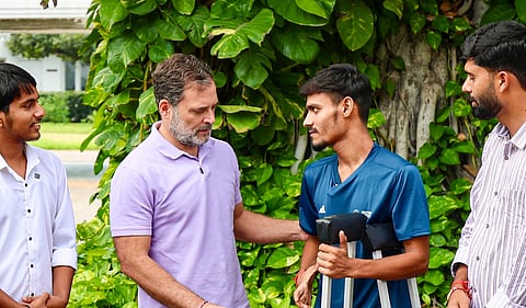 Leader of Opposition in the Lok Sabha Rahul Gandhi interacts with students from Bihar injured during protests against alleged irregularities in examination system, at his residence, in New Delhi. (@RahulGandhi/X via PTI Photo)