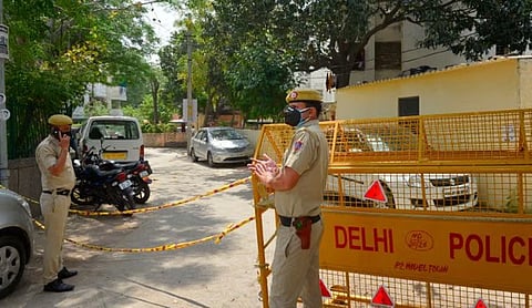 Delhi Police personnel at a cordoned-off street in Model Town, Delhi.