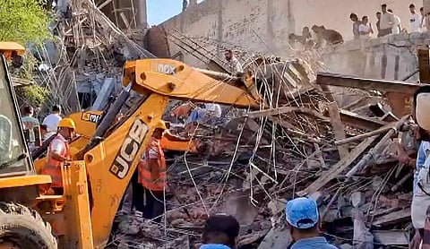 the collapsed building at Dhulkot village, AMBALA on Monday, September 28. (PTI Photo)
