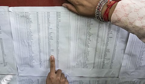 Family members search for the names of their kin on a list of people rescued following devastating flash floods at an Army camp in Trishuli, Nuwakot district, Nepal, MUMBAI on Saturday, August 29. (PTI Photo)
