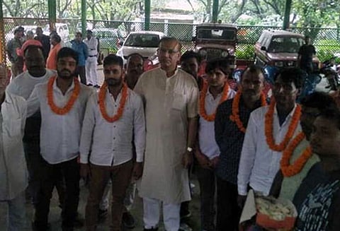 கொலை குற்றவாளிகளுக்கு மாலை அணிவிப்பு; மந்திரி சின்ஹாவுக்கு எதிராக நாடாளுமன்றத்தில் கோஷம்