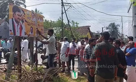 கோவில் வழிகாட்டி பலகை மீது தி.மு.க. போஸ்டர் ஒட்டியதால் பரபரப்பு