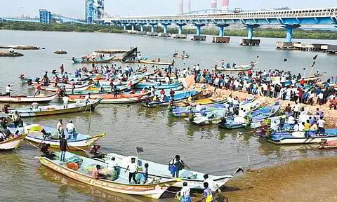 மீன்பிடி பகுதியில் உயர் மின்கோபுரம் அமைக்க எதிர்ப்பு; 8 மீனவ கிராம மக்கள் கொசஸ்தலை ஆற்றில் படகில் சென்று போராட்டம்
