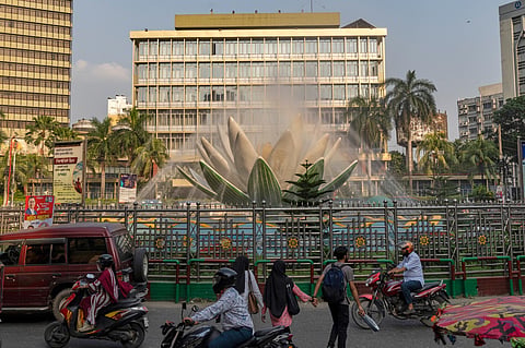 Vehicles and pedestrians pass by the Shapla Chattar fountain in front of Bangladesh Bank in Dhaka, Bangladesh, Wednesday, May 6, 2026. AP Photo