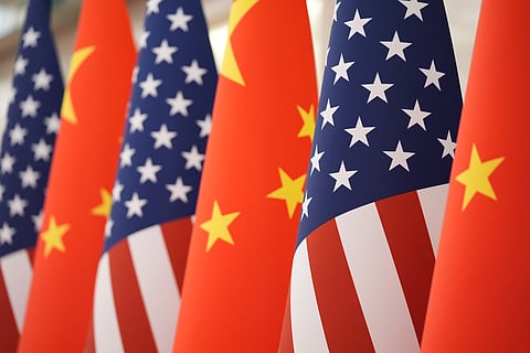 The US and Chinese flag at the Great Hall of the People prior to the state dinner of President Donald Trump and Chinese President Xi Jinping on May 14, 2026, in Beijing.