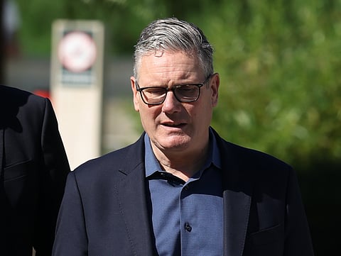 Britain’s Prime Minister Keir Starmer walks, as he visits a housing development in north London, Friday, June 19, 2026.