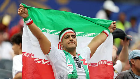 A fan waves the Iran flag during their match against Belgium in Los Angeles on Monday.
