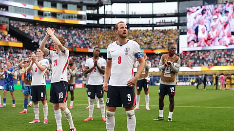 England captain Harry Kane stands with his team after the match.