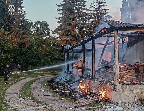 In this photo, provided by the Ukrainian Emergency Service, firefighters extinguish a fire in a residential building following a Russian drone attack in Sumy region, Ukraine, 26 June, 2026.