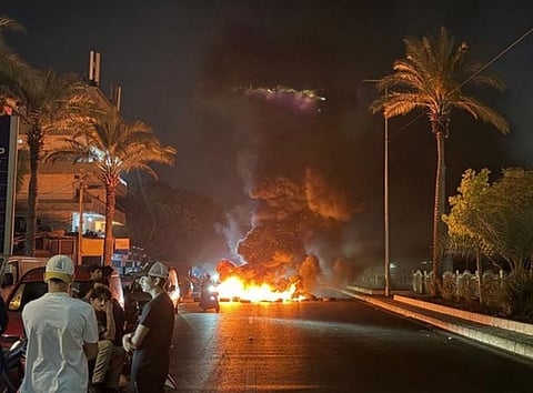 Hezbollah supporters block the old airport road in the southern suburbs of Beirut, with burning tires to protest against the trilateral agreement that was signed between the US, Israel and Lebanon.