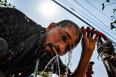 A man cools off during a break from work. For workers, escaping Dhaka's heat is nearly impossible. (File Photo)