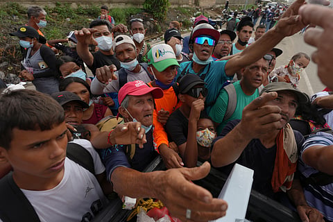 People reach out to receive supplies from volunteers, days after an earthquake struck La Guaira, Venezuela, 30 June 2026.