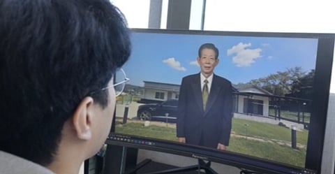 Lee Geon Hui looks at a computer screen as a video clip shows a digital likeness of his late grandfather speaking at Seoul-based tech firm Vaice, South Korea, Friday, June 12, 2026.