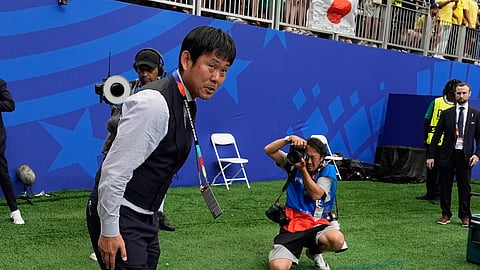 Japan head coach Hajime Moriyasu bows after the World Cup round of 32 match between Brazil and Japan in Houston on Monday