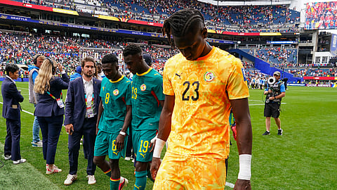 Senegal goalkeeper Mory Diaw (23) hangs his head while leaving the pitch after a loss during the World Cup round of 32 match between Belgium and Senegal in Seattle on Wednesday