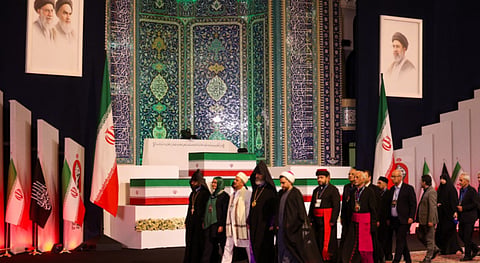 Thousands of mourners carrying red banners, a symbol associated with calls for revenge, gather in the courtyard of Tehran's Grand Mosalla.