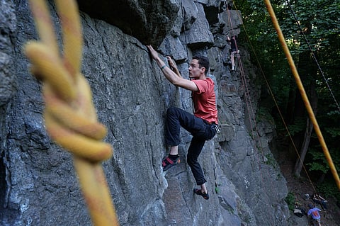 A man climbs on a cliff during the Stoned Climbers festival near Denyshi, Zhytomyr region, Ukraine, 27 June 2026.