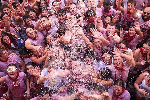 Revelers celebrate as the txupinazo, the traditional rocket marking the start of the San Fermín festival, kicks off nine days of uninterrupted festivities in Pamplona, Spain, 6 July 2026.