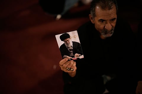 A man holds a picture of the late Iranian Supreme Leader Ayatollah Ali Khamenei on the eve of funeral ceremonies in Karbala, Iraq, 7 July 2026, as the dayslong funeral ceremonies continue in Iraq with events in the Shiite holy cities of Karbala and Najaf.