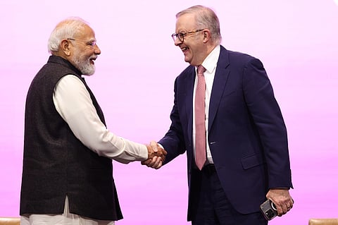 Indian Prime Minister Narendra Modi, left, is welcomed to the stage by Australian Prime Minister Anthony Albanese to address the Australia-India Economic Roadmap Business Reception in Melbourne, Australia, 9 July 2026.