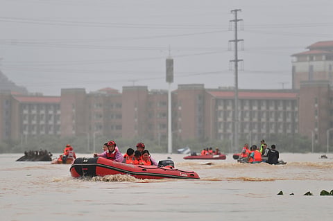 In this photo released by Xinhua News Agency, rescuers evacuate stranded teachers and students at Xijiang education park in the aftermath of tropical storm Maysak in Guigang City, south China's Guangxi Zhuang Autonomous Region, 8 July 2026.