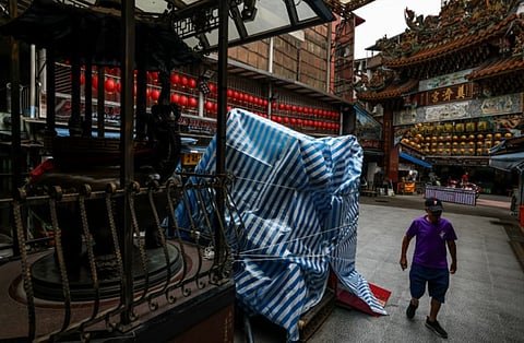 Locals in the port city of Keelung, which is expected to be one of the hardest hit areas, stocked up on food, taped windows, and stacked sandbags at the entrances to street-level businesses, heeding warnings from authorities to take precautions.