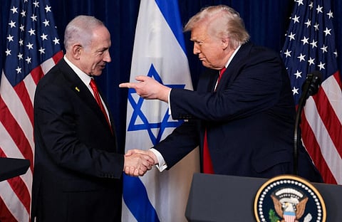 Trump points his finger towards Netanyahu as they shake hands during a press conference in Palm Beach, Florida, U.S., December 29, 2025