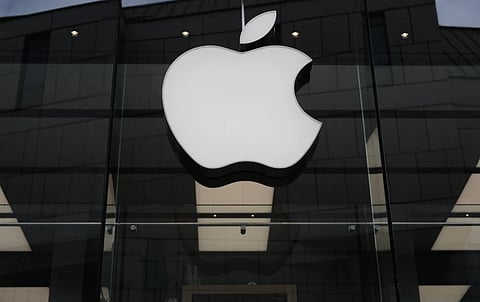 The Apple logo is illuminated at a store in Munich, April 2, 2026.