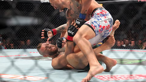 Conor McGregor (red gloves) fights Max Holloway (blue gloves) in a welterweight bout during UFC 329 at T-Mobile Arena.