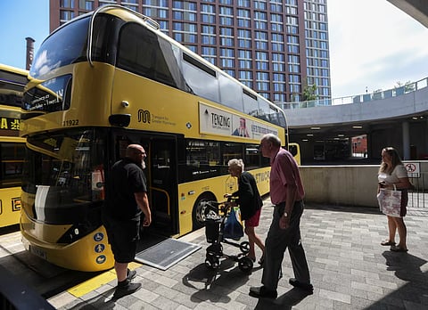 Passengers board a Bee Network bus at Stockport Interchange in Stockport, Britain, July 14, 2026.