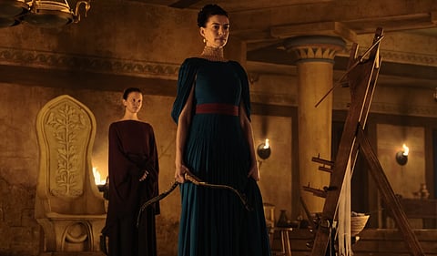 Anne Hathaway as Penelope, in a scene from “The Odyssey.” Mia Goth, left, plays the servant Melantho.