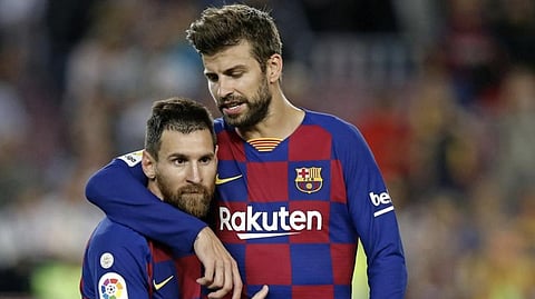Gerard Pique with Lionel Messi