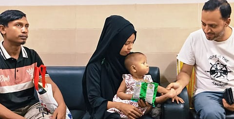 Two-year-old Anifa Akter, suffering from a rare congenital condition, is pictured with her parents.