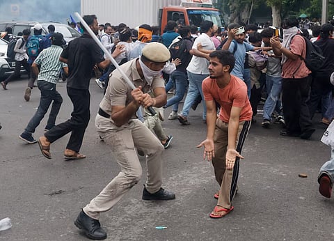 Police use batons to disperse supporters of the Cockroach Janta Party as they march toward parliament on the opening day of its monsoon session, demanding the resignation of Education Minister Dharmendra Pradhan over exam paper leaks, in New Delhi, India, 20 July, 2026.