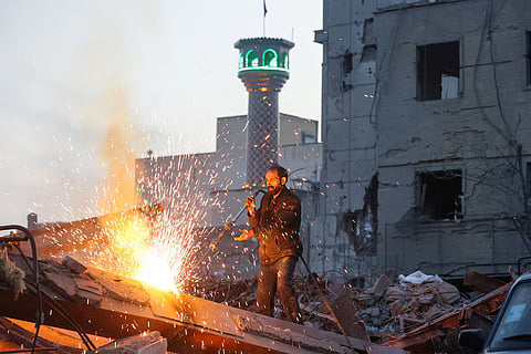A man works amid debris, following an Israeli and US strike on a police station, amid the US-Israel conflict with Iran, in Tehran, Iran, March 2, 2026.