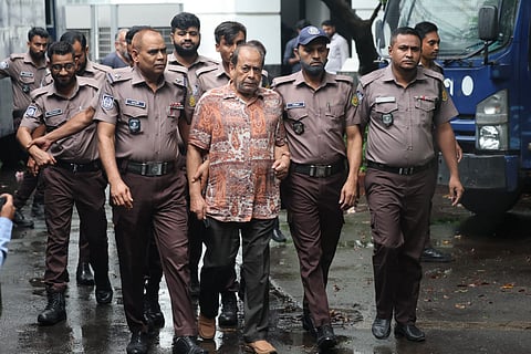Police escort former Major Mozaffar Hossain to the International Crimes Tribunal on Thursday.