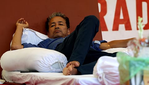 Sonam Wangchuk, an Indian education reformer, who has been on hunger strike, rests on stage during a sit-in protest called by CJP demanding the resignation of Indian Education Minister Dharmendra Pradhan, at Jantar Mantar in New Delhi, India, July 14, 2026.