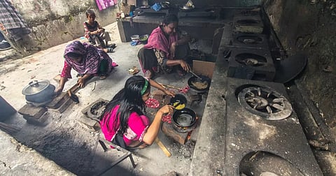 Residents cook on makeshift brick stoves as low gas pressure disrupts household cooking in Navodaya housing in Mohammadpur, Dhaka, on Sunday (July 26)