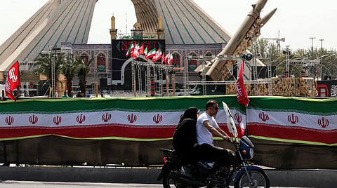 Visitors pass an Iranian missile display in Tehran as diplomatic efforts continue to ease tensions between Iran and the United States.