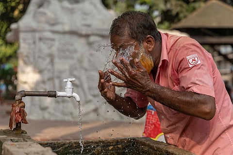 A man cools himself off during the intense noon heat.