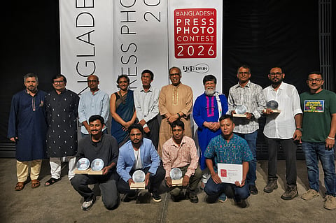 Judges and winners of the Bangladesh Press Photo Contest pose for a photograph during the award ceremony at DrikPath Bhaban, Panthapath, Dhaka, on Friday.