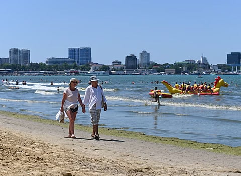 People relax on a beach during the vacation season in the Black Sea resort city of Anapa, Russia, July 6, 2026.
