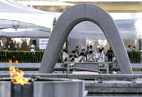 Visitors pray in front of the cenotaph dedicated to the victims of the atomic bombing ahead of a ceremony to mark the anniversary of the bombing at the Hiroshima Peace Memorial Park in Hiroshima, western Japan Thursday, Aug. 6, 2026.