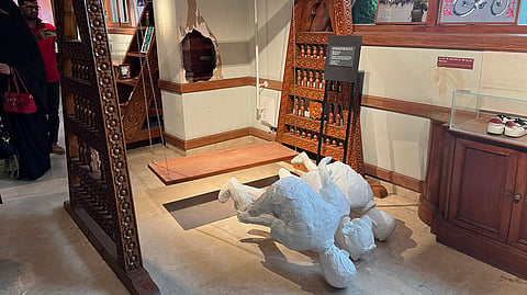 The sculpture of three children killed during the July Uprising remains lying face-down on the floor.