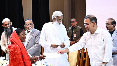 Prime Minister Tarique Rahman distributes honorariums among priests and temple caretakers.
