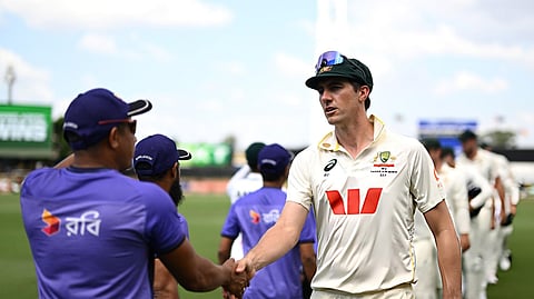 Australia's Pat Cummins shakes hands with Bangladesh staff after defeat in the first Test.