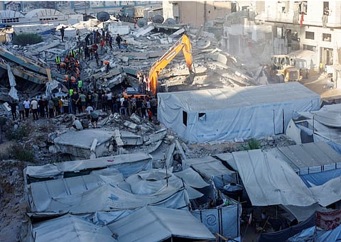 Civil Defence workers attempt to rescue people trapped beneath the rubble of a residential building that had been damaged in an earlier Israeli strike during the war and collapsed on Wednesday, in Gaza City, September 16, 2026.