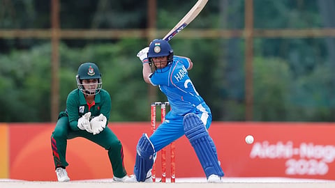 India captain Harmanpreet Kaur bats as Nigar Sultana Joty looks on in the Asian Games semifinal.